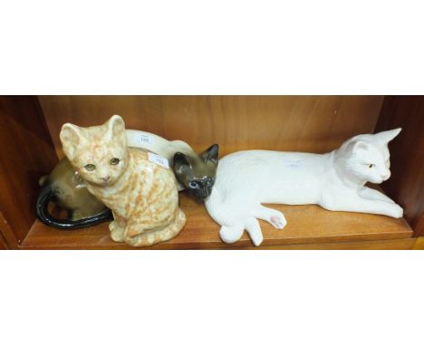 A Winstanley standing marmalade cat model, signed, size 4, 24cm high and two other ceramic cat models, (3).