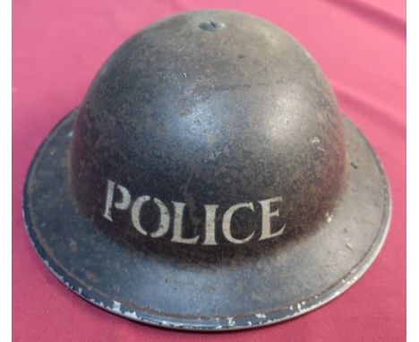 British WWII period steel helmet, complete with liner and chin strap, with blackened top, the front marked Police 