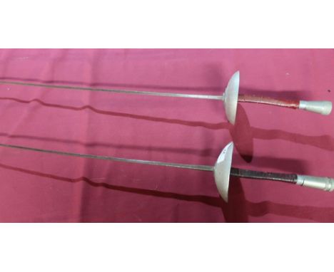 Two fencing foils, one then blade marked Wilkinson, the other with aluminium cut guard marked Leon Paul (2) 