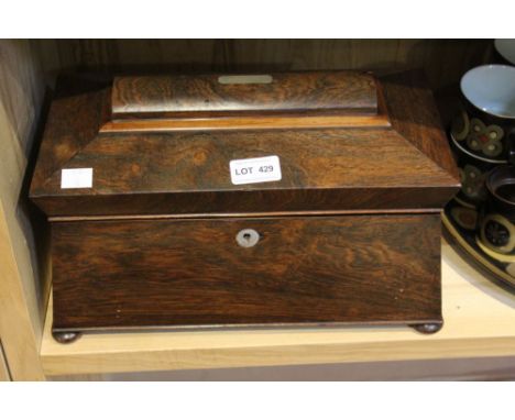 A 19th century, Regency tea caddy of sarcophagus form, the lid hinges open to reveal two inner caddies, raised on bun feet 34