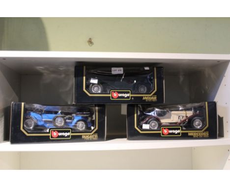 Three box Burago model cars, Jaguar, Mercedes, and Bugatti
