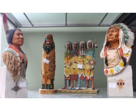 A shelf containing four models of native Americans in various medium