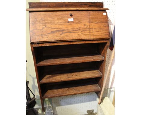 A small oak fall front students desk over open book shelves&nbsp;