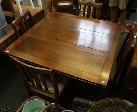 A draw leaf table with six chairs with tapestry upholstered seat pads