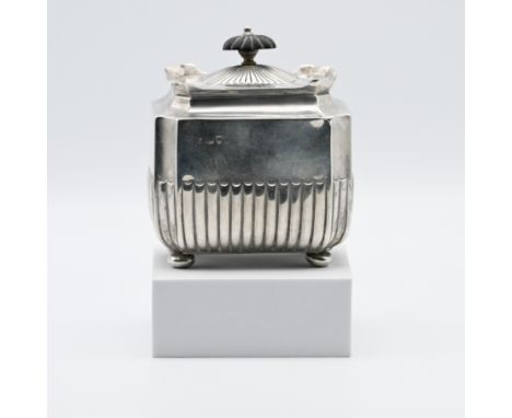 A silver tea caddy of octagonal shape with bun feet and hinged lid with a turned finial, London hallmark, Mappin Brothers, Lo