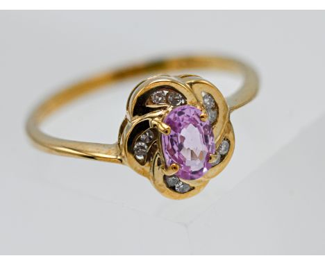 9ct yellow gold pink sapphire &amp; diamond oval shaped cluster ring  Central 6.00 x 4.00mm oval cut pink sapphire, surrounde