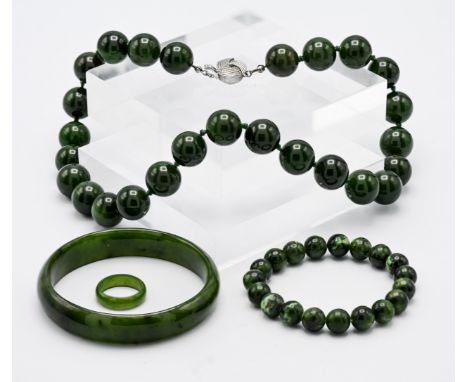 A collection of modern Jade style' jewellery including bangle, bead necklace, bead bracelet and ring (4).