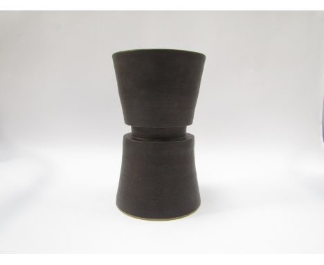 A studio pottery "diablo" form cylindrical vase, manganese glaze, in the Hans Coper style. Impressed seal to base. 27cm high 