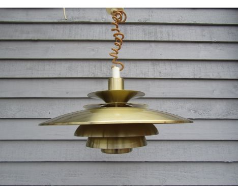 A brassed seven tiered ceiling light with push pull hanging 