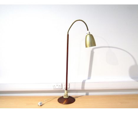 A circa 1950's standard lamp, anodised copper base with adjustable single spot