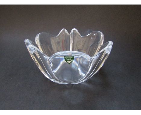 An Orrefors clear glass bowl of flower form, labelled, 10cm high x 16cm diameter 