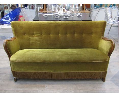 A 1940's Danish three seater sofa in olive green velor upholstery, shaped arms and splayed supports, 159cm x 72cm x 80cm