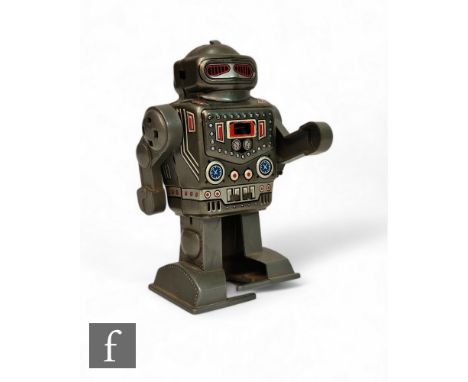 A Yonezawa Captain robot, clockwork tinplate toy with plastic arms and feet, sparking feature to chest, integral key, height 
