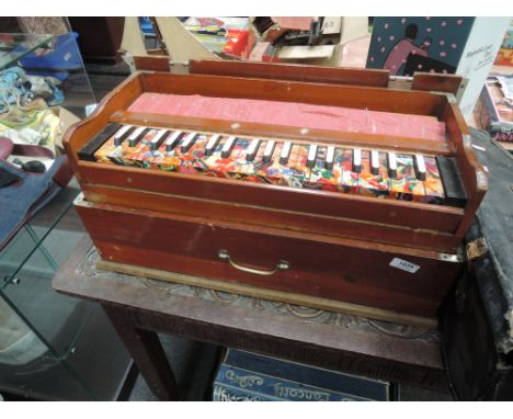 A vintage preacher style organ, with bellows in lid, keys having psychedelic decoration