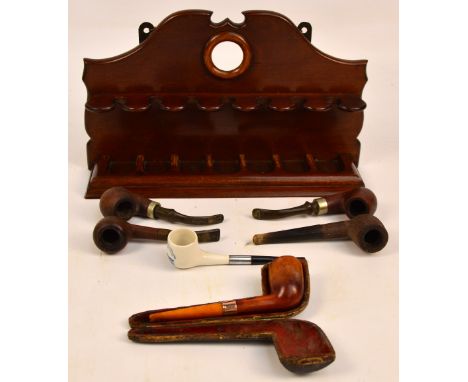 A small collection of pipes including "Duncan", "Bruyere St Claude", "Super Bent", ceramic with windmills, and a cased pipe w