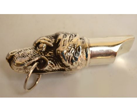 A modern silver whistle, stamped 925, also fully hallmarked to the ring held in dog's mouth, length 5cm, approx 0.3ozt.