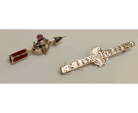 Two hallmarked silver brooches, one modelled as an arrow centred with a thistle and set with stones, Birmingham 1906, the oth