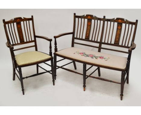 An Edwardian mahogany satinwood inlaid three piece parlour suite comprising two seater settee and a pair of matching armchair