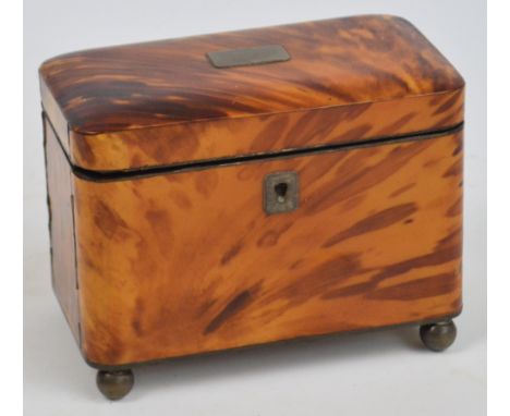 A mid 19th century blonde tortoiseshell two division tea caddy of rounded rectangular form, the hinged lid enclosing two tort