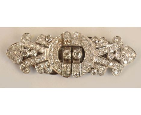 An Art Deco white metal diamond set brooch/double clip, the pierced main frame centred with two collet set diamonds, each wei