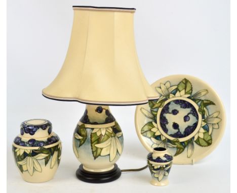 Four pieces of modern Moorcroft decorated in the "Juneberry" pattern; plate, ginger jar and cover, small baluster vase and ta