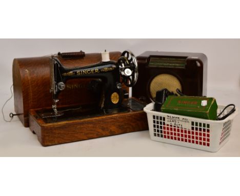 A vintage Bush radio, an angle poise lamp and a Singer sewing machine with accessories.