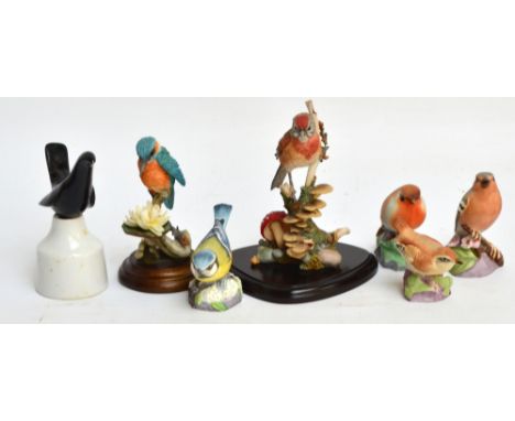 Four Royal Worcester matt birds; robin, chaffinch, blue tit, and wren, a boxed Royal Worcester blackbird pie funnel, and two 