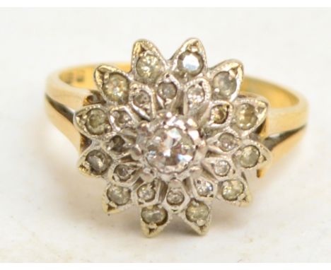 An 18ct yellow gold floral cluster ring, the central brilliant cut diamond of approx 0.2cts surrounded by two rows of diamond