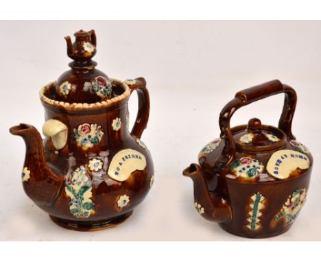 A Victorian barge ware treacle glaze teapot "To A Friend" applied moulded decoration, height 29cm and a kettle with "Love At 