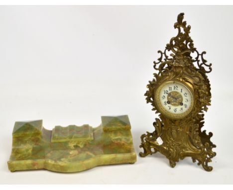 A 20th century French metal mantel clock of pierced scrolling floral and foliate design, the circular white enamel chapter ri