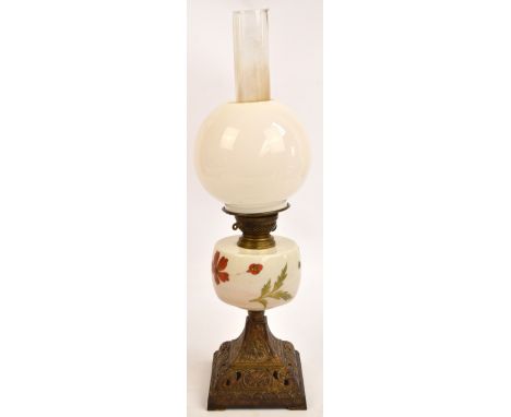 A late 19th century oil lamp with opaque globular shade, floral painted reservoir and gilt heightened cast iron base, height 