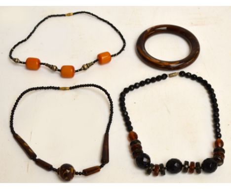 A small collection of beaded necklaces with various sizes and colours, and a brown bangle (4).
