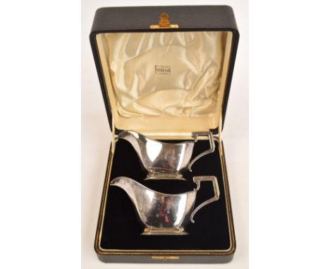 A cased pair of George V Art Deco hallmarked silver sauce boats, Birmingham 1937, length 17.5cm, approx 12ozt, retailed by Fi