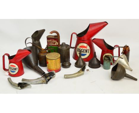 A collection of vintage oil cans and funnels including Regent, Wesco, etc.