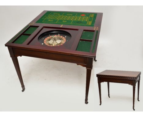 An Edwardian mahogany double folding games table, the hinged rectangular lid opening to reveal a baise playing surface with d