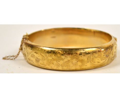 A 9ct yellow gold snap bangle with bright cut decoration on one side, approx 21.7g.