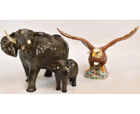 Three Beswick figures; bald eagle, no.1018 and two elephants (trunk stretching), no.974 and 998 (3). CONDITION REPORT: Eagle 