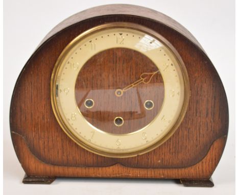 An Art Deco oak cased Westminster chiming eight day mantel clock, the circular chapter ring set with Arabic numerals, height 
