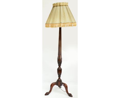 A mahogany standard lamp, the tapering fluted column carved with wheat, sheaf and acanthus decoration, with fluted baluster k