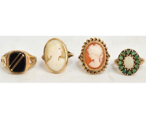 Four 9ct yellow gold dress rings comprising two cameo examples, one opal and emerald coloured stone cluster ring and one sign