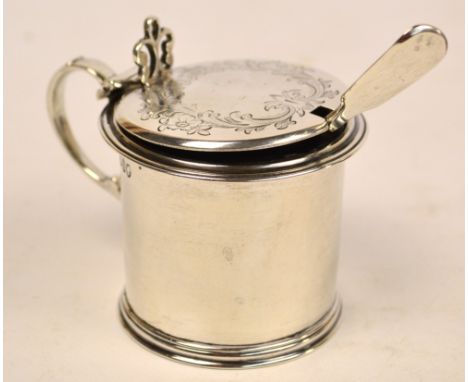 A Victorian hallmarked silver drum mustard with hinged foliate engraved lid, blue glass liner and matching spoon, London 1865