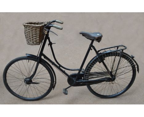 A vintage bicycle with wicker basket and Brooks saddle.