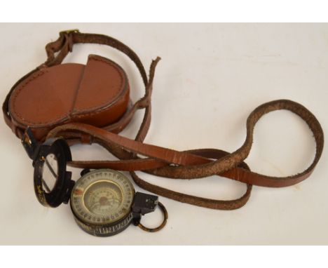 A WWII fluid damped MkIII British Army compass, impressed "TG Co Ltd London no. B186511" and dated 1942m with broad arrow mar
