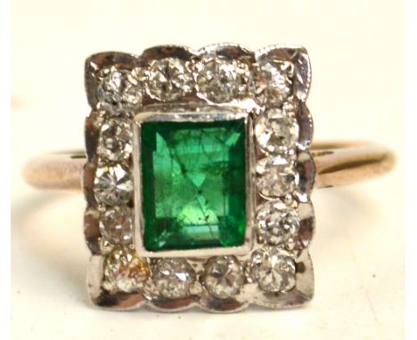 A square Art Deco emerald and diamond ring, the rectangular and emerald surrounded by fourteen small diamonds on a pierced ga