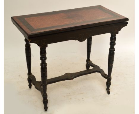 A late 19th century aesthetic ebonised rectangular foldover card table on ring turned stretchered supports, width 86cm.