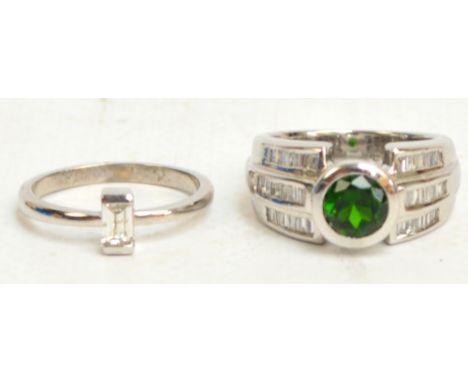 An 18ct white gold modern diamond and green hardstone ring, the gallery with heart shaped piercing and the shoulders with thr