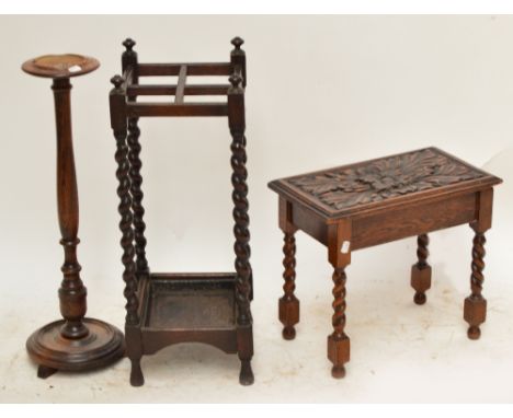 An early 20th century oak four division stick stand, an oak stool carved by Macclesfield carver Graham Bramwell, and an oak s