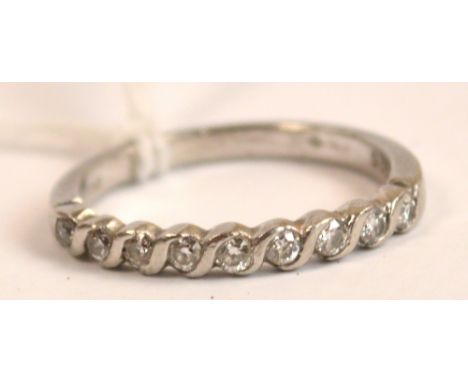 A platinum diamond set half eternity ring, size M.