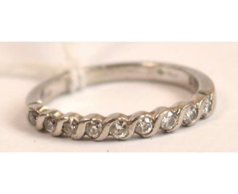 A platinum diamond set half eternity ring, size M.