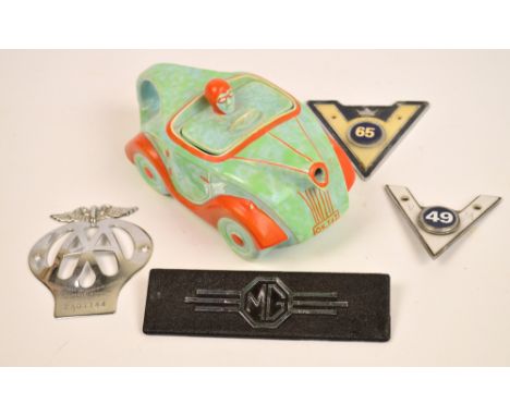 An Art Deco Sadler teapot modelled as a racing car, reg no.820236 and four car badges; AA, MG and two Company of Veteran Moto